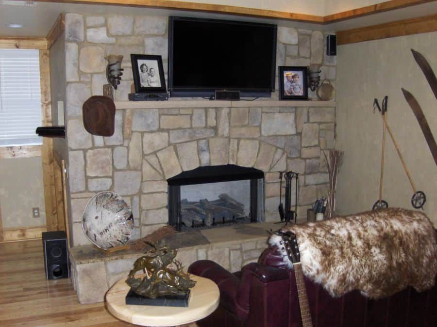 A living room with a fireplace and a flat screen tv