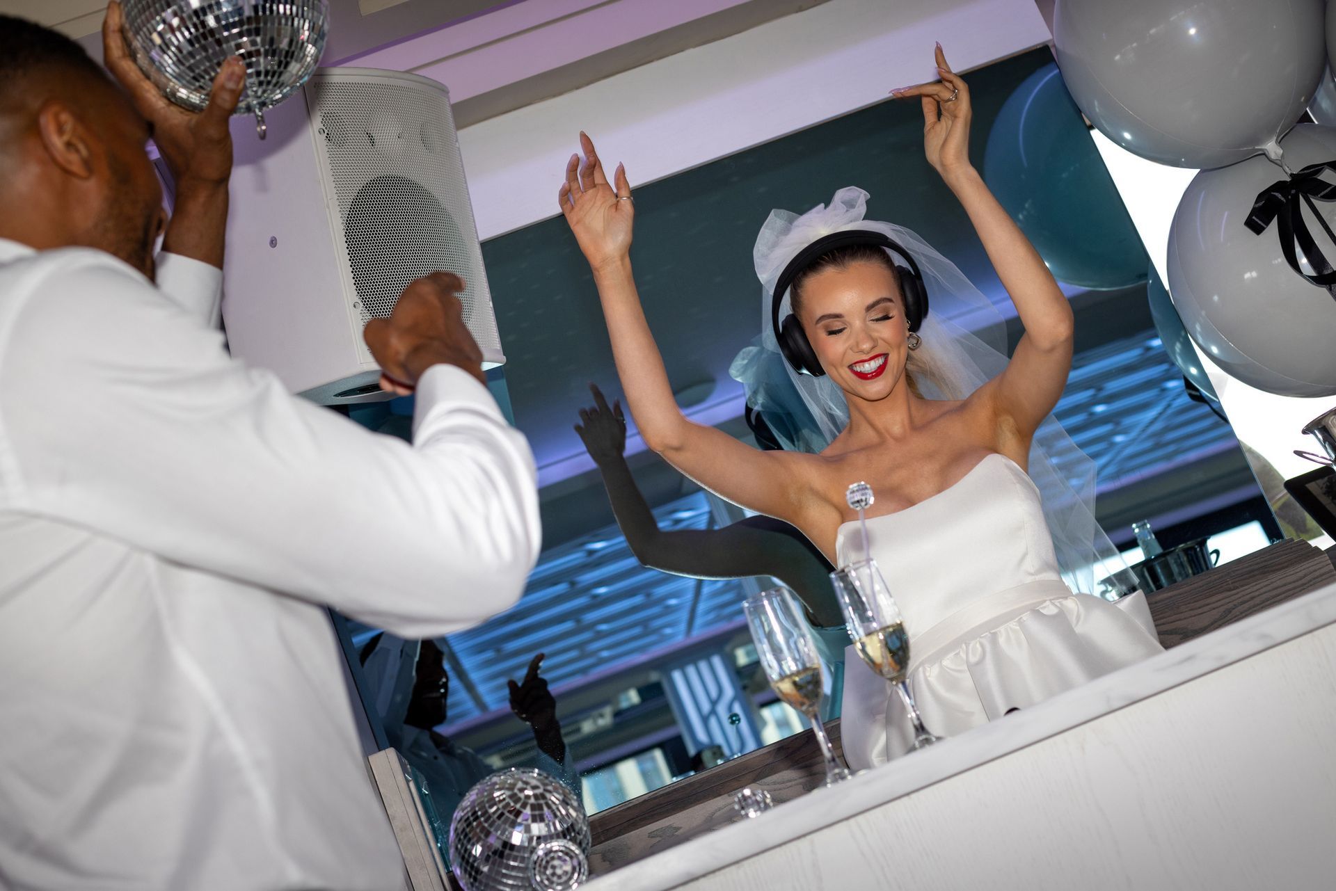A bride and groom are dancing at a wedding reception.