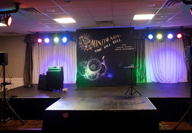 There is a stage in the middle of the room with lights on it.