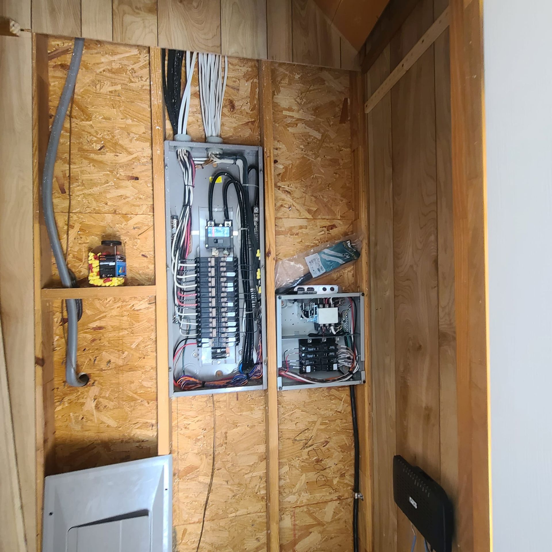A wooden wall with electrical panels on it
