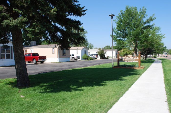 Row of mobile homes with trees