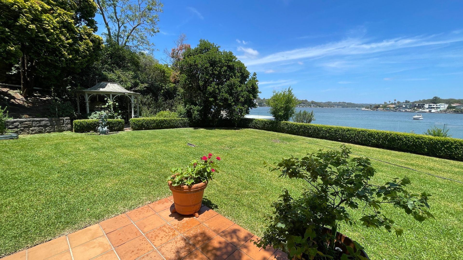 Parking area with low hedge in front of a building.