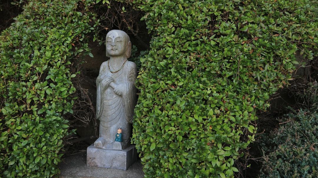 concrete garden statue in landscaped garden - concrete garden decorations