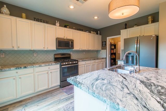 Spanish Hills white kitchen with marble countertops