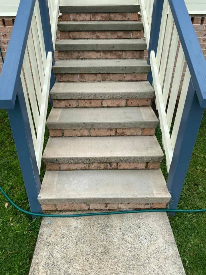 A Set of Stairs Leading Up to a Deck With a Blue Railing — Doobies Cleaning Service in South West Rocks, NSW