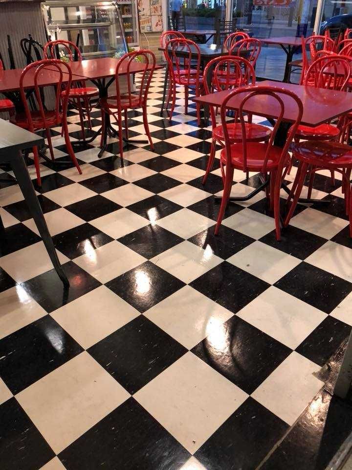 A Restaurant With Red Tables and Chairs and a Checkered Floor — Doobies Cleaning Service in Port Macquarie, NSW