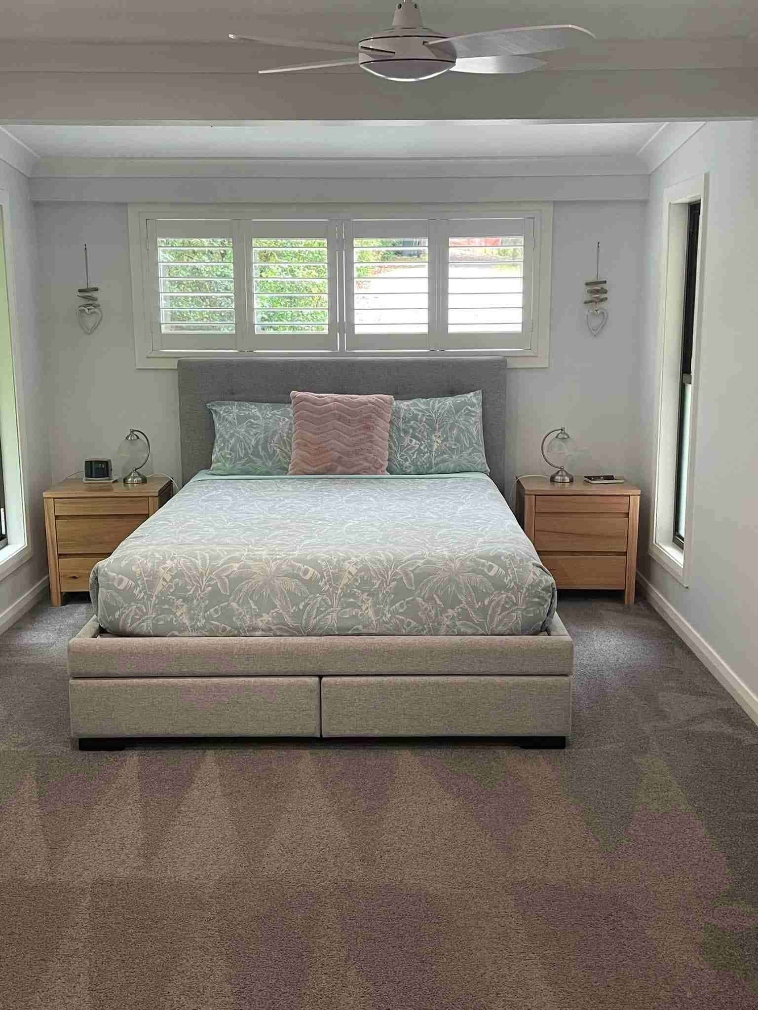A Bedroom With a Bed , Nightstands , and a Ceiling Fan — Doobies Cleaning Service in South West Rocks, NSW