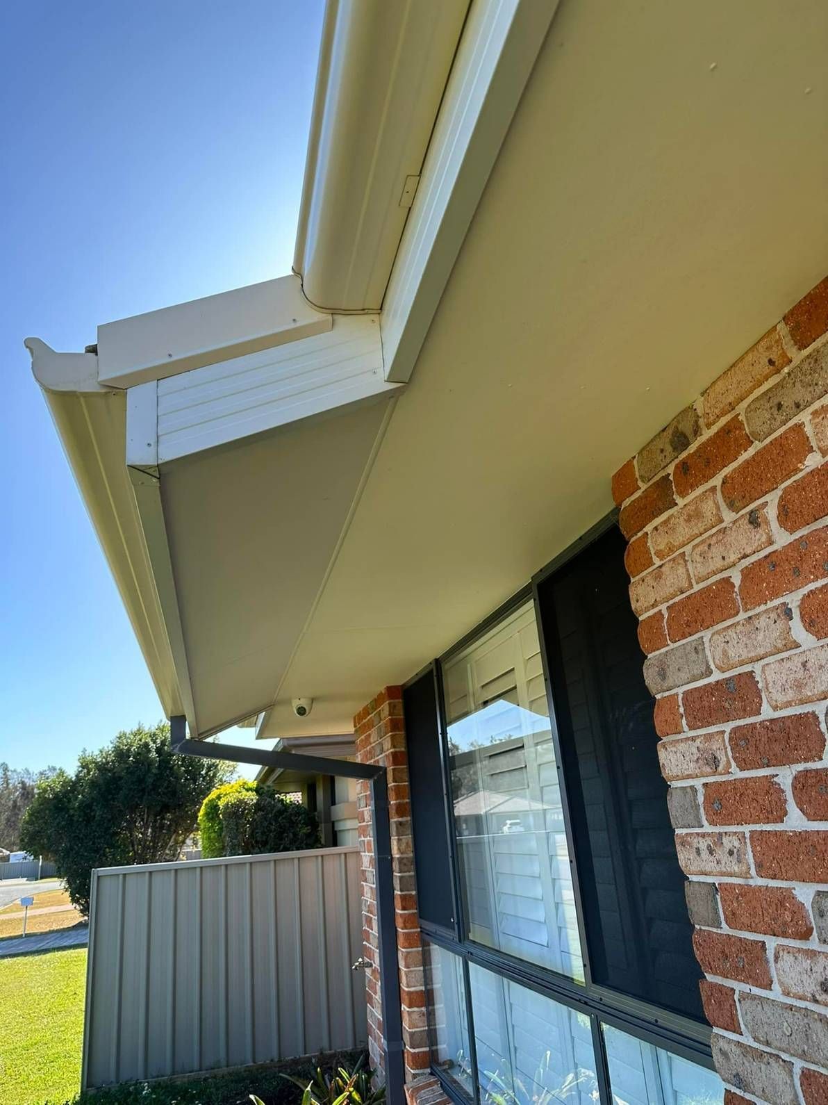 A Brick House With a White Roof and a Black Window — Doobies Cleaning Service in Port Macquarie, NSW