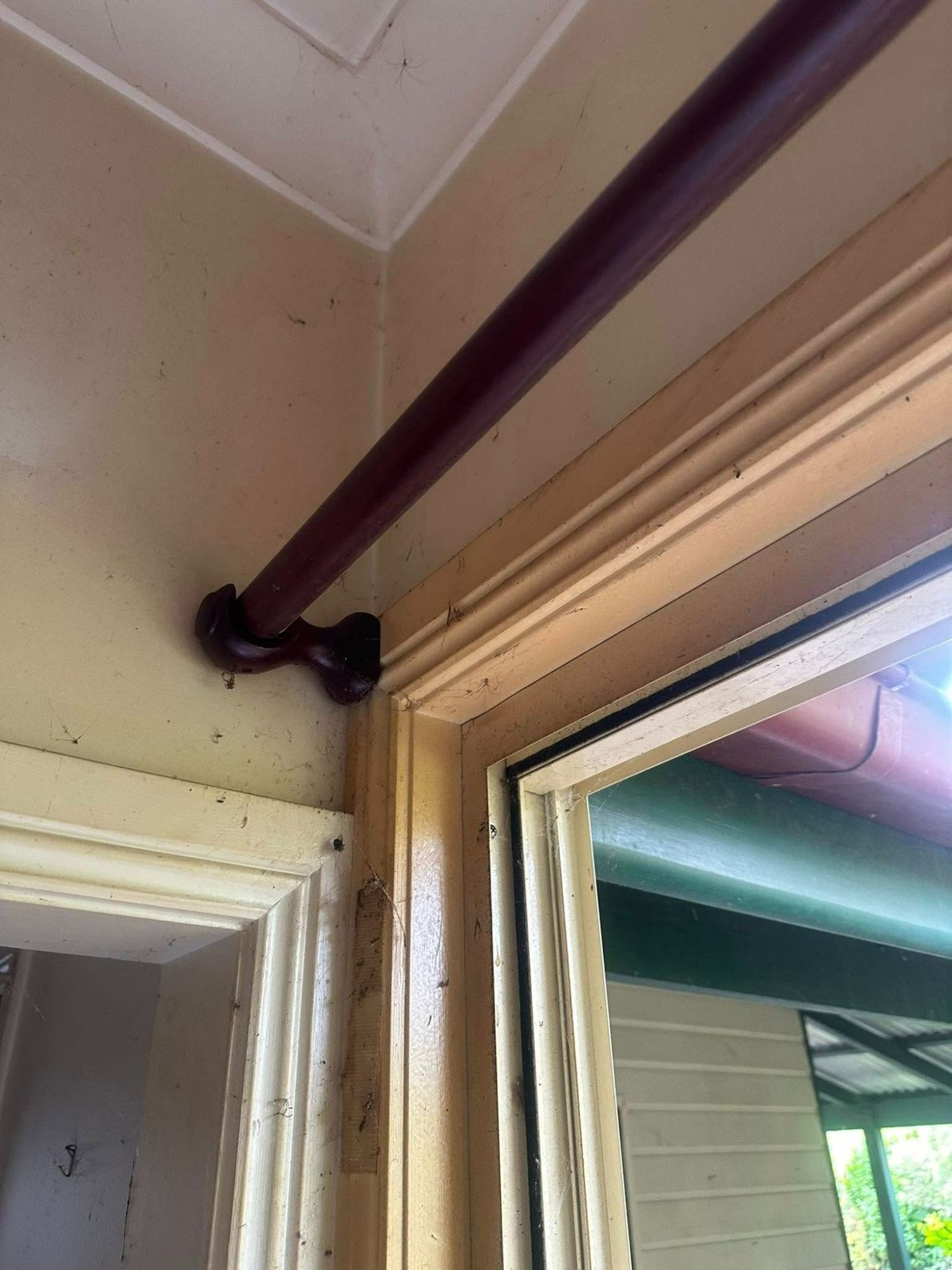 A Close Up of a Window With a Curtain Rod Hanging From the Ceiling — Doobies Cleaning Service in Port Macquarie, NSW