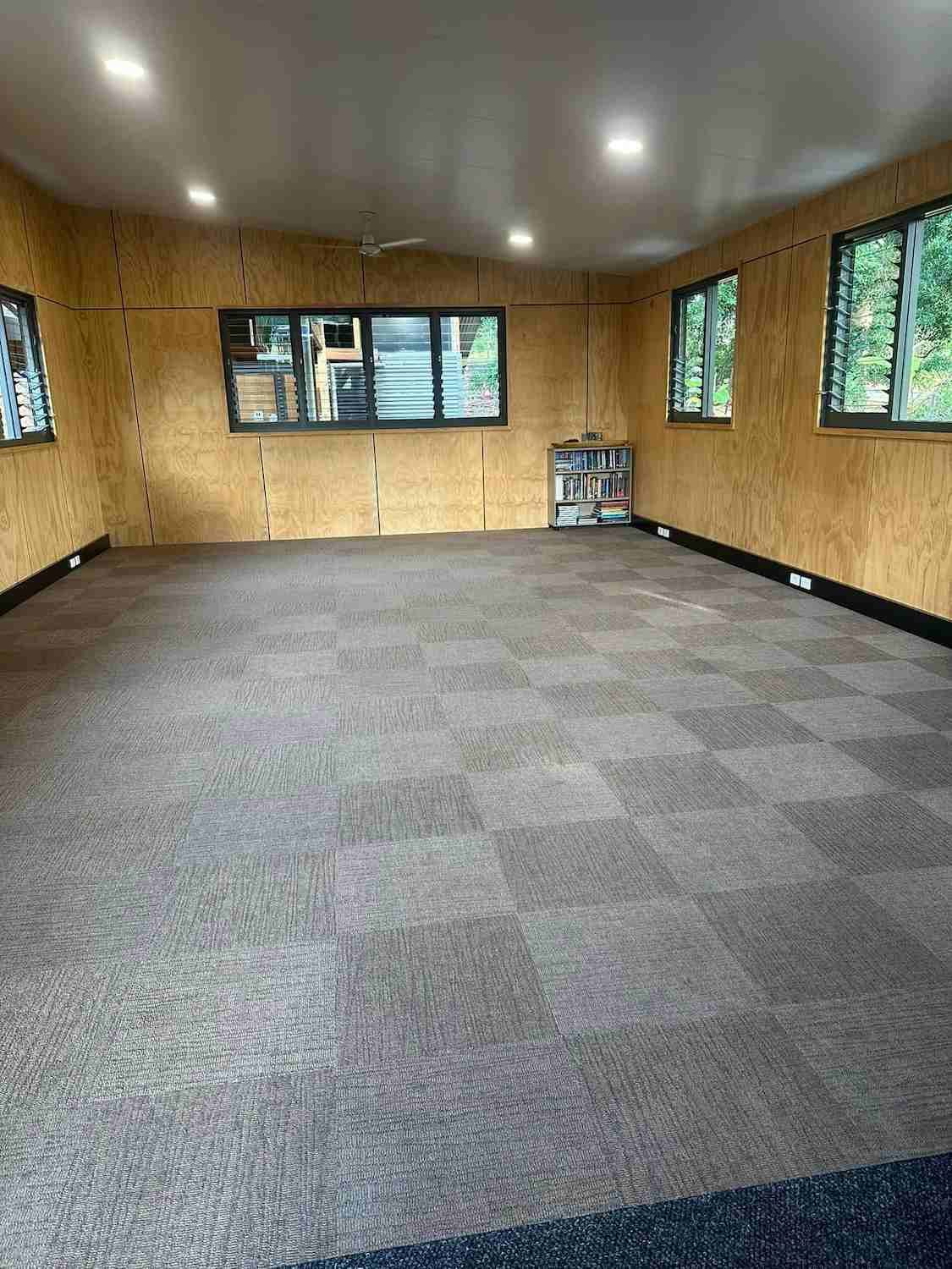 A Large Room With a Carpeted Floor and Lots of Windows — Doobies Cleaning Service in Port Macquarie, NSW