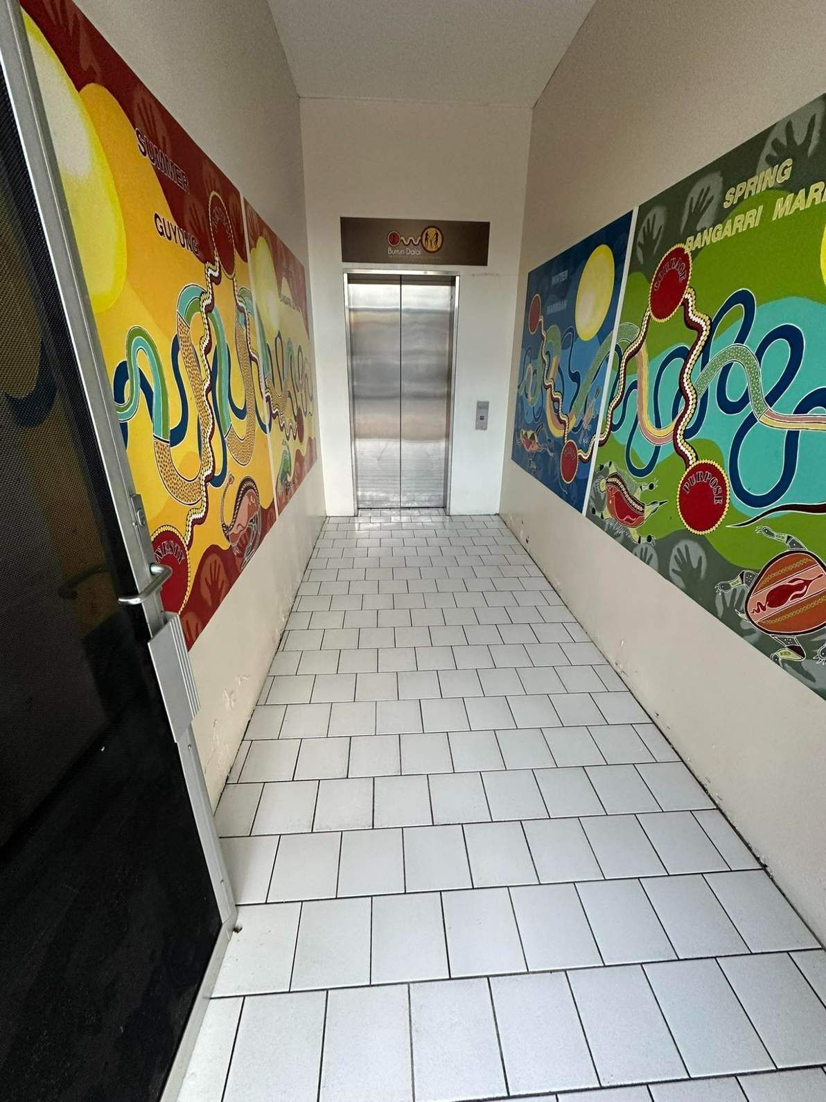 A Hallway With a Painting on the Wall and an Elevator — Doobies Cleaning Service in South West Rocks, NSW