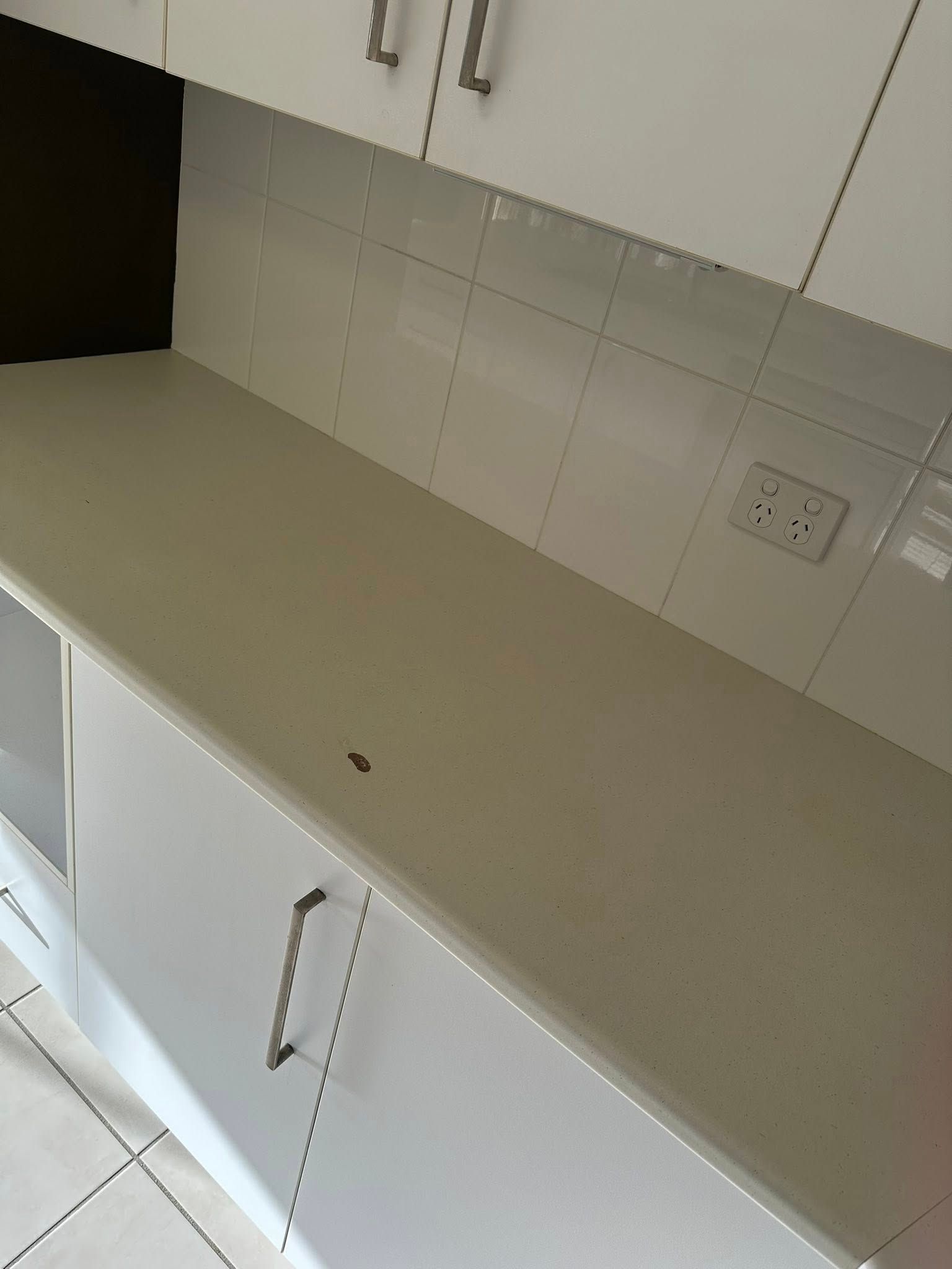 A Kitchen Counter With White Cabinets and a White Counter Top — Doobies Cleaning Service in Port Macquarie, NSW