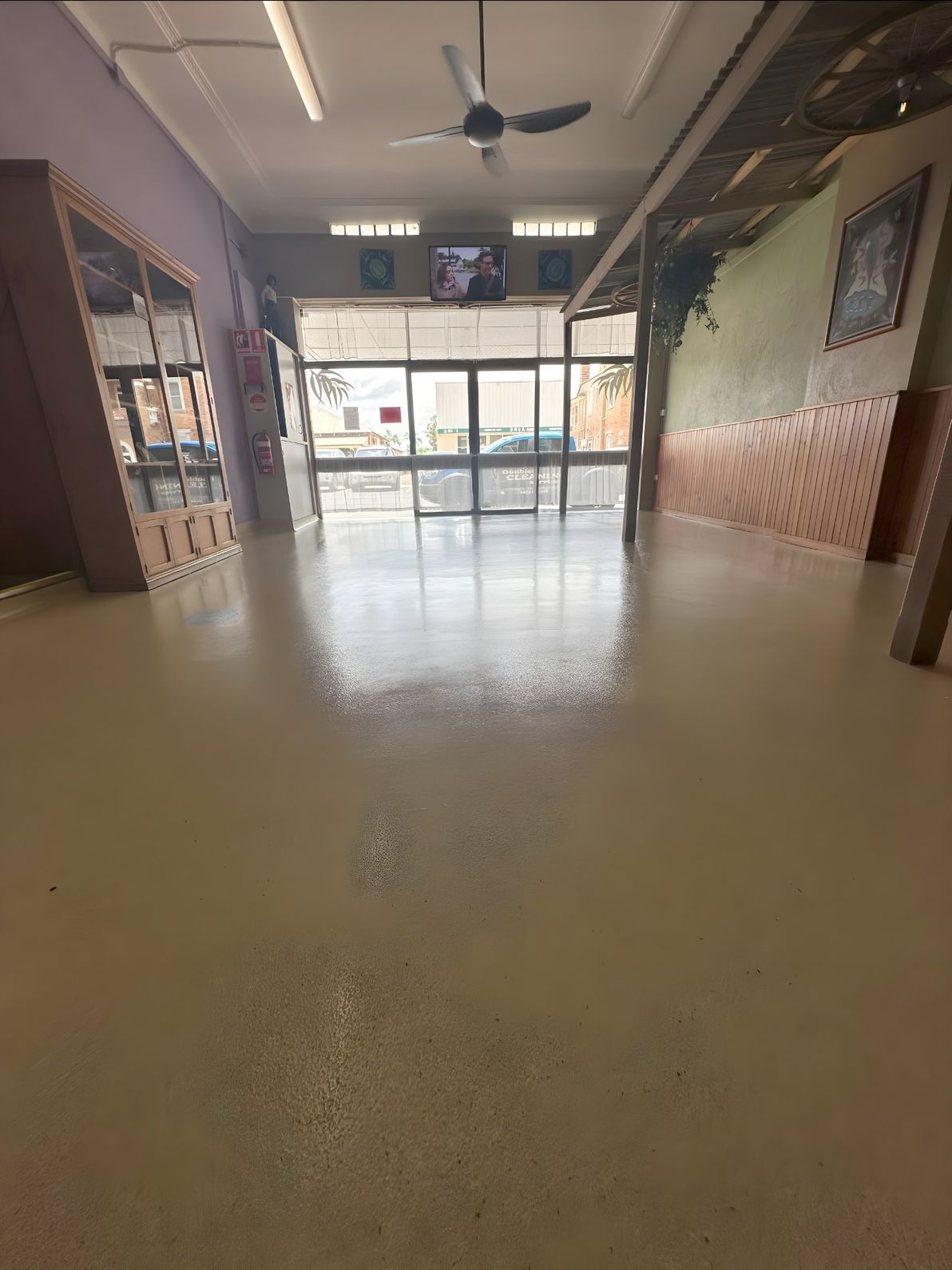 A Large Empty Room With a Ceiling Fan and a Lot of Windows — Doobies Cleaning Service in Port Macquarie, NSW