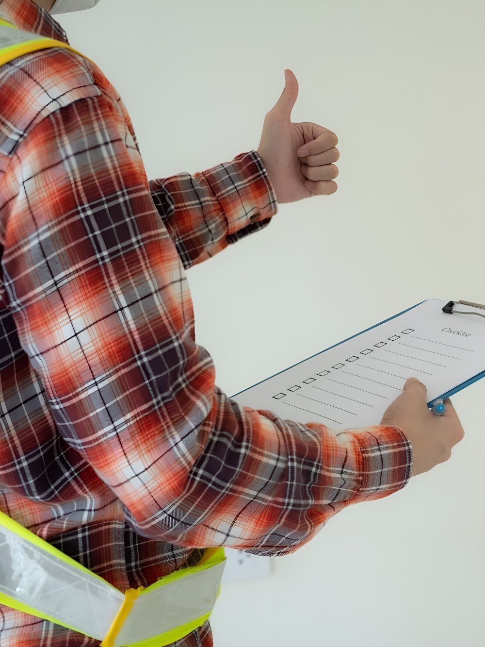 A Man In A Plaid Shirt Is Holding A Clipboard And Giving A Thumbs Up — GEO – AM Consulting In Lismore, NSW