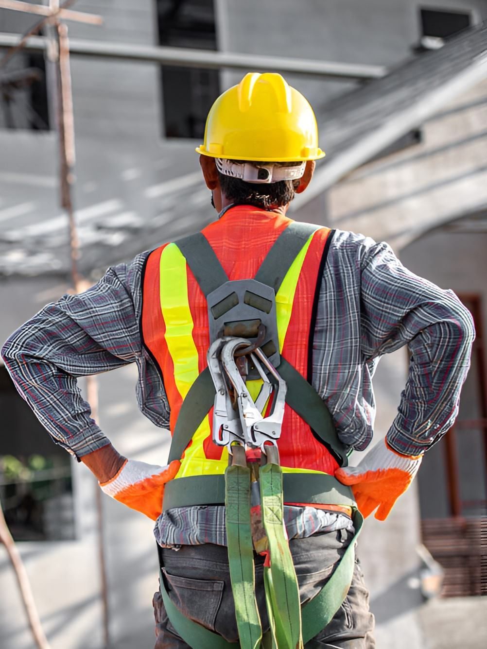 A Construction Worker Wearing A Hard Hat And Safety Harness — GEO – AM Consulting In Lismore, NSW