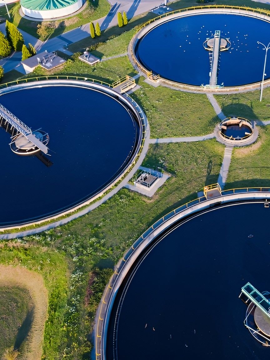An Aerial View Of A Sewage Treatment Plant Surrounded By Grass And Water — GEO – AM Consulting In Lismore, NSW