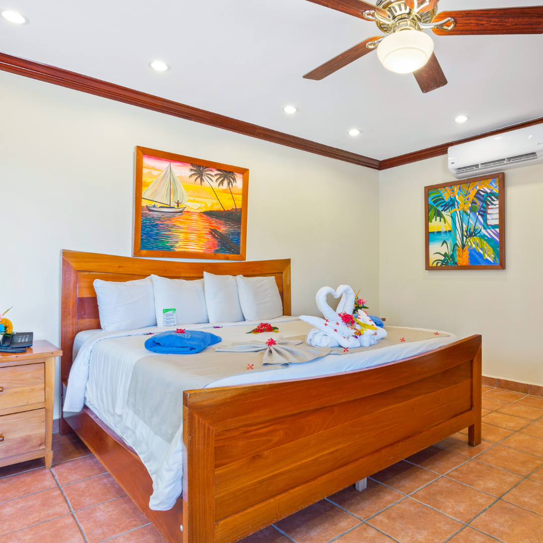 a bedroom with a large bed and a ceiling fan