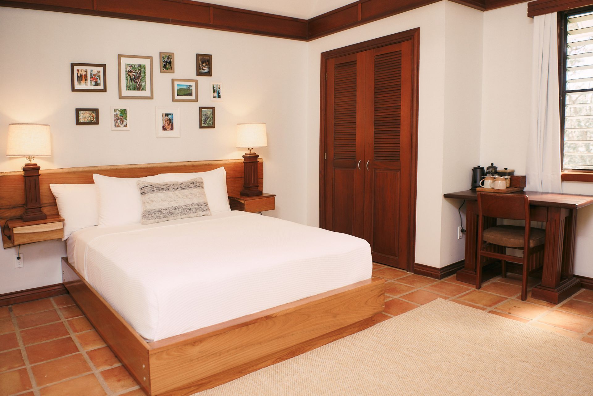 a bedroom with a large bed and a desk