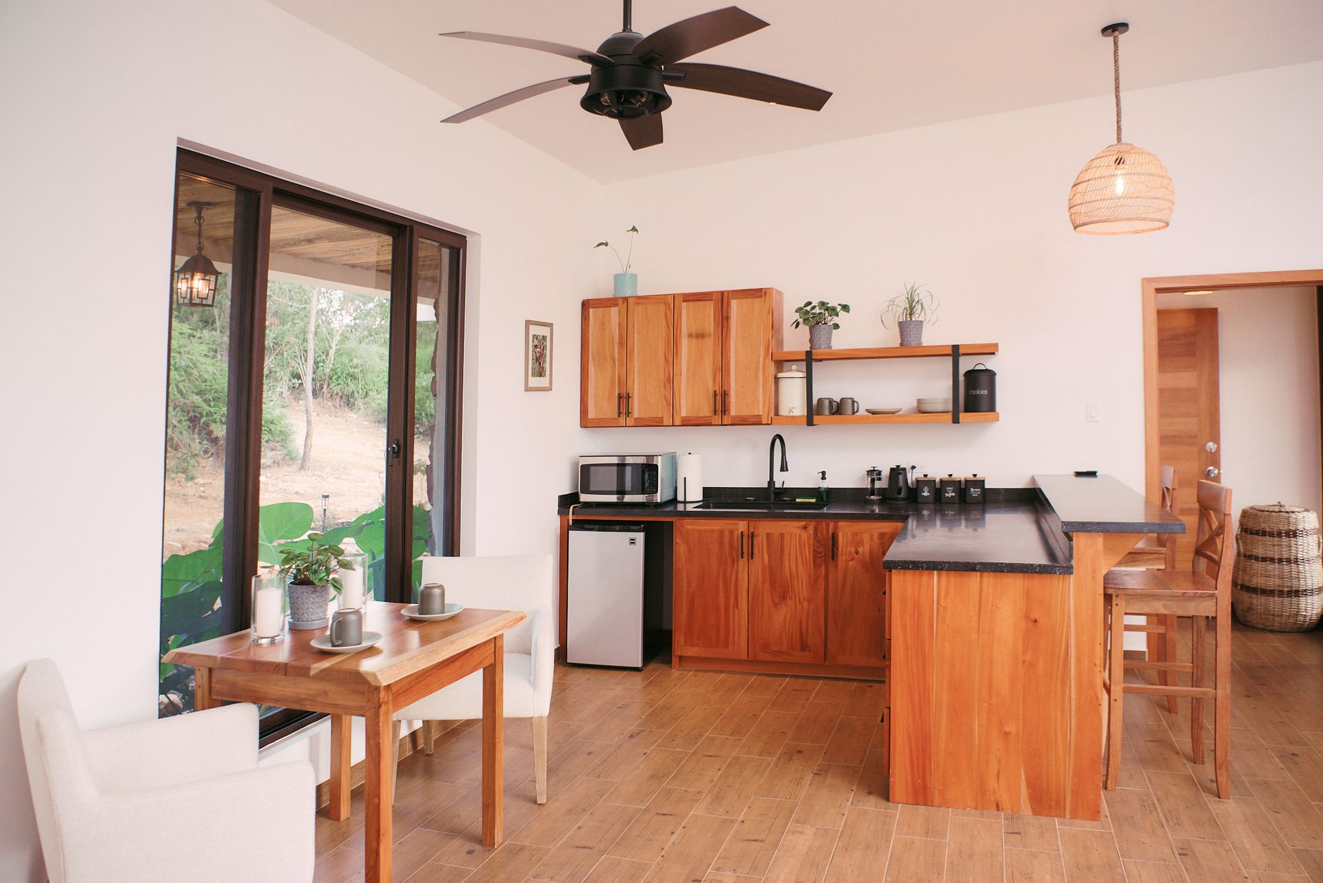 A kitchen with wooden cabinets and a ceiling fan
