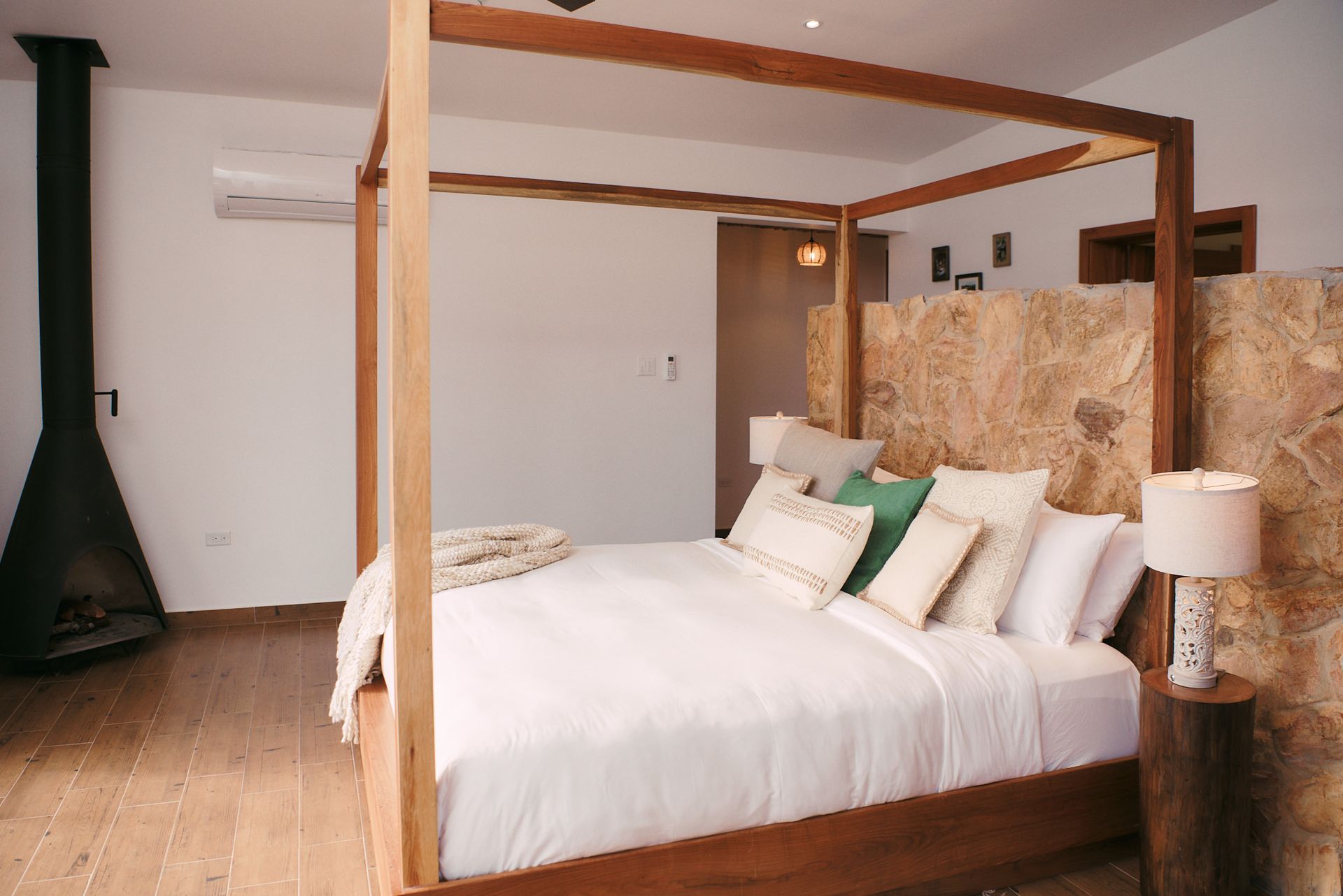 a bedroom with a canopy bed and a fireplace .