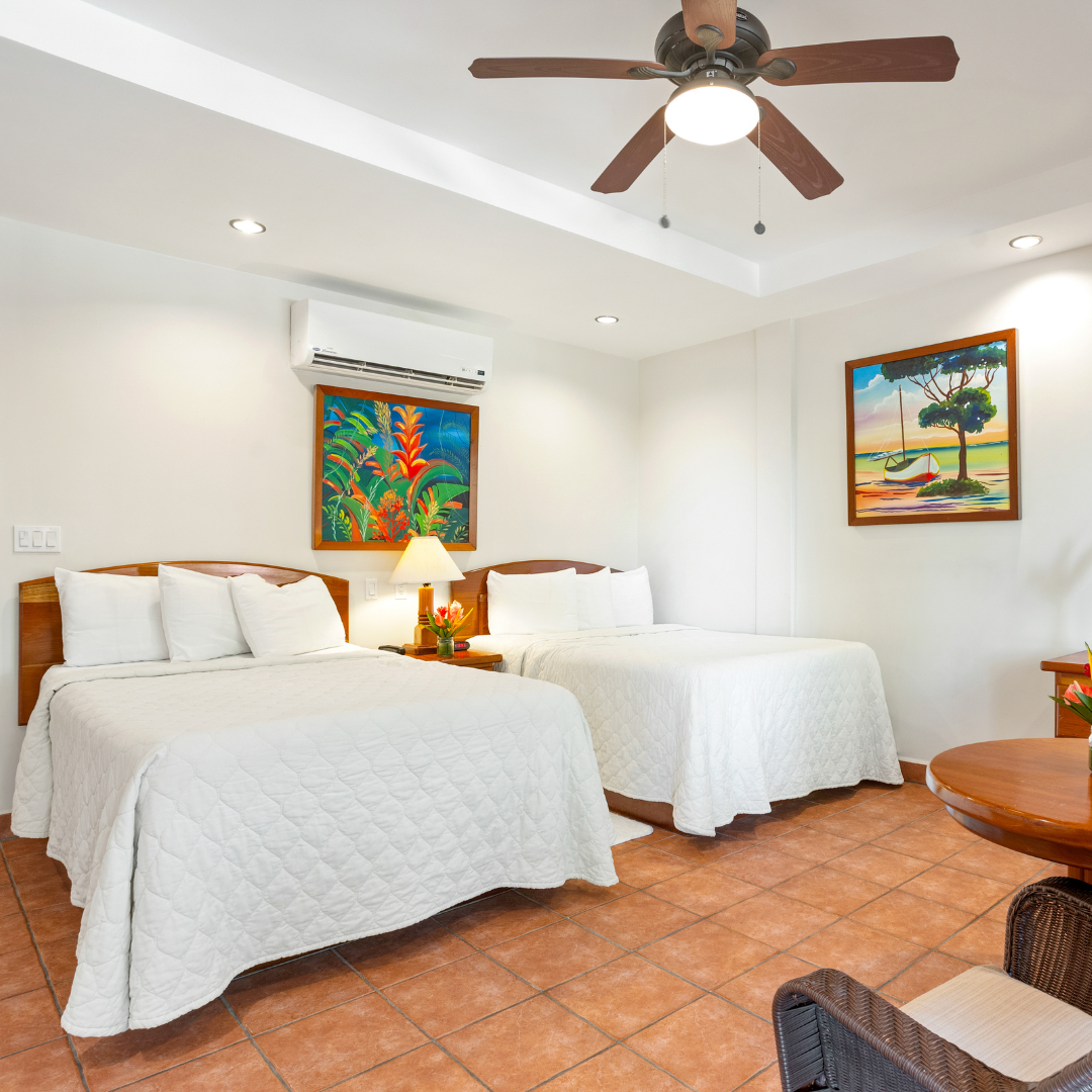 a hotel room with two beds and a ceiling fan