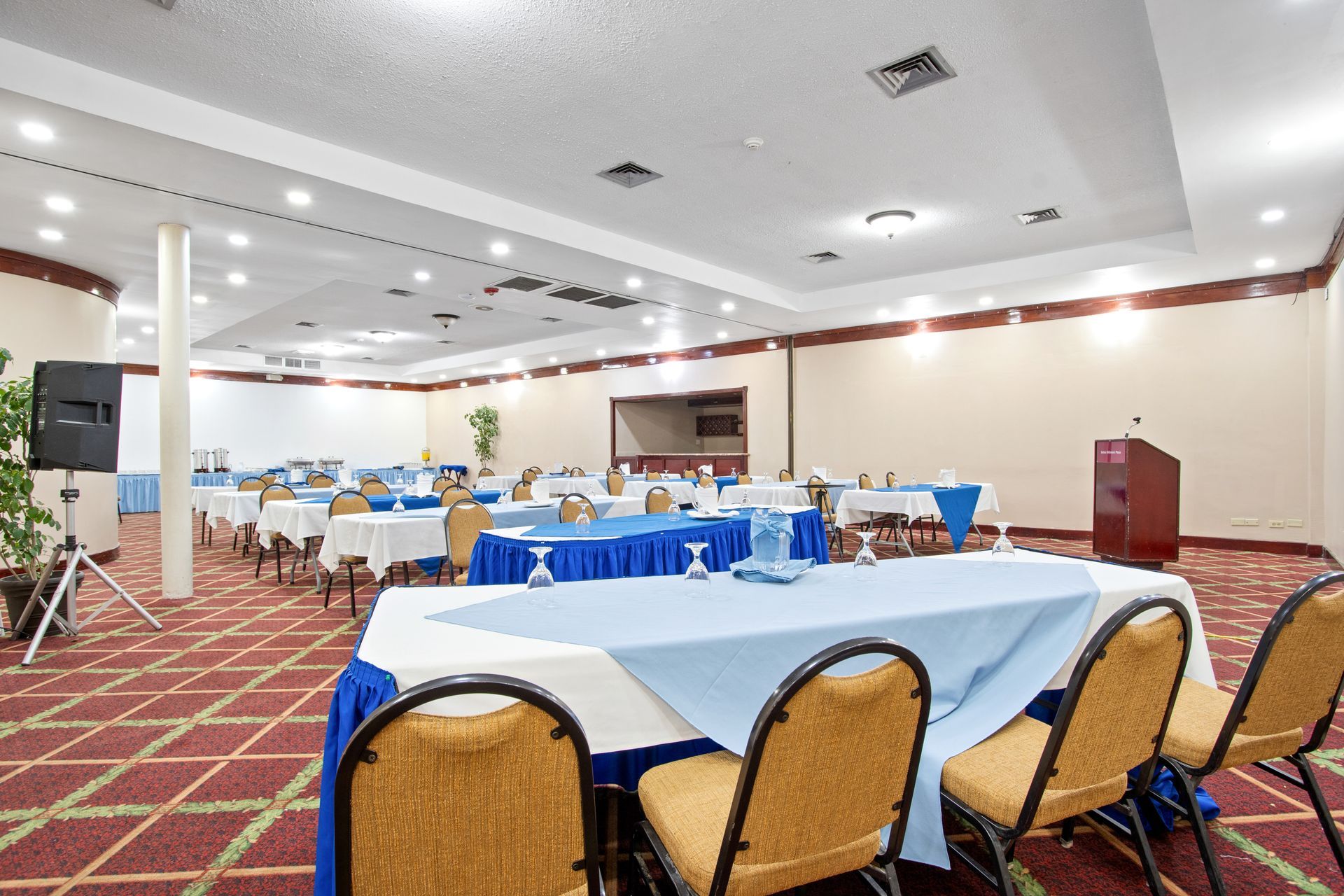 A conference room with tables and chairs set up for a meeting