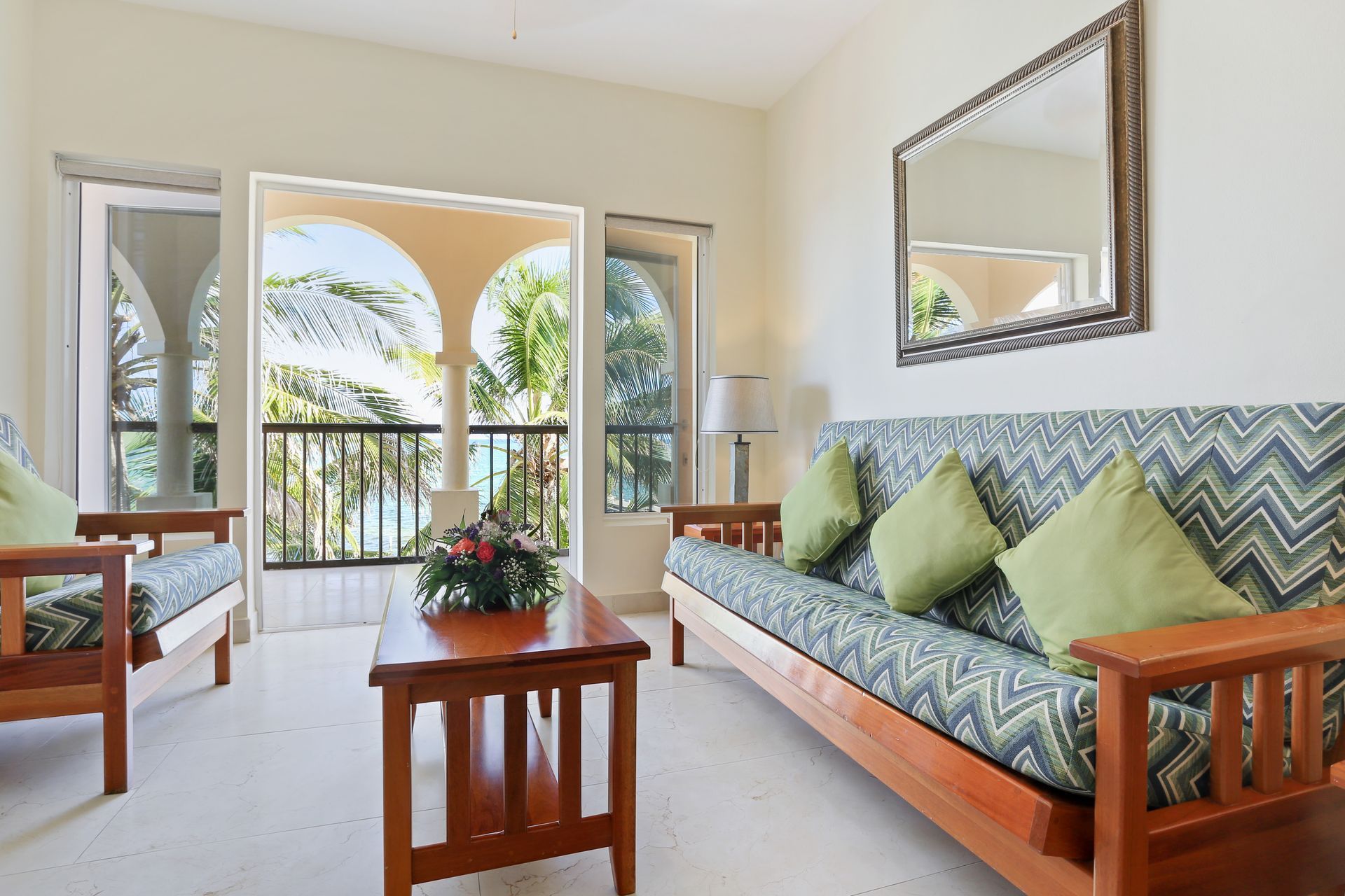 A living room with a couch and two chairs