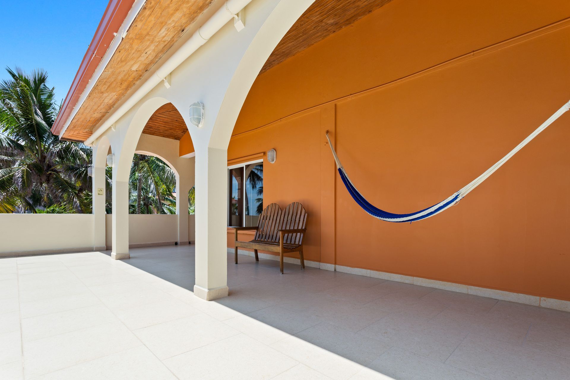 A hammock is hanging from the side of a building