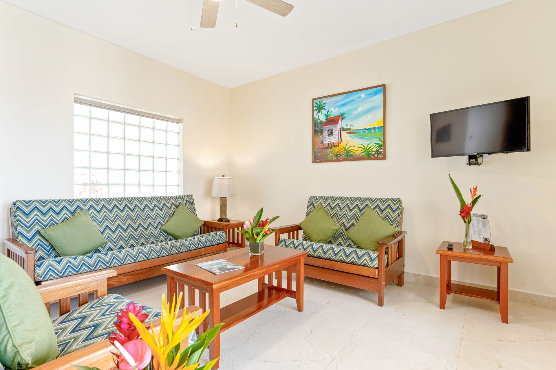 A living room with two couches , a coffee table , and a flat screen tv.