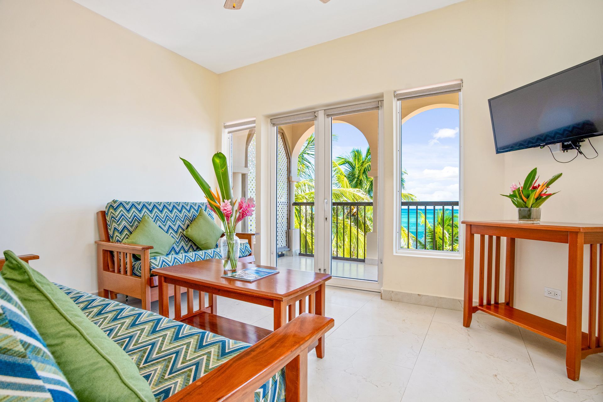 A living room with a couch , table , and television.