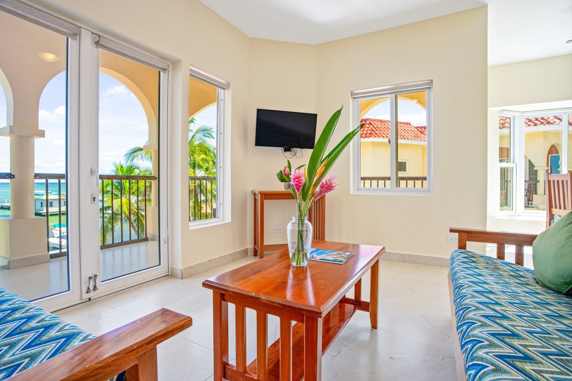 A living room with a couch , table , and television.