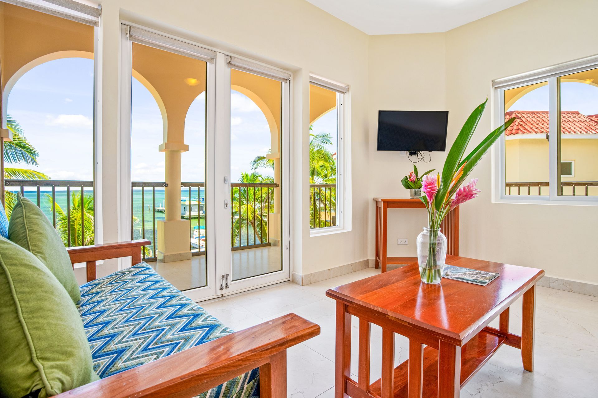 A living room with a couch , coffee table , and television.