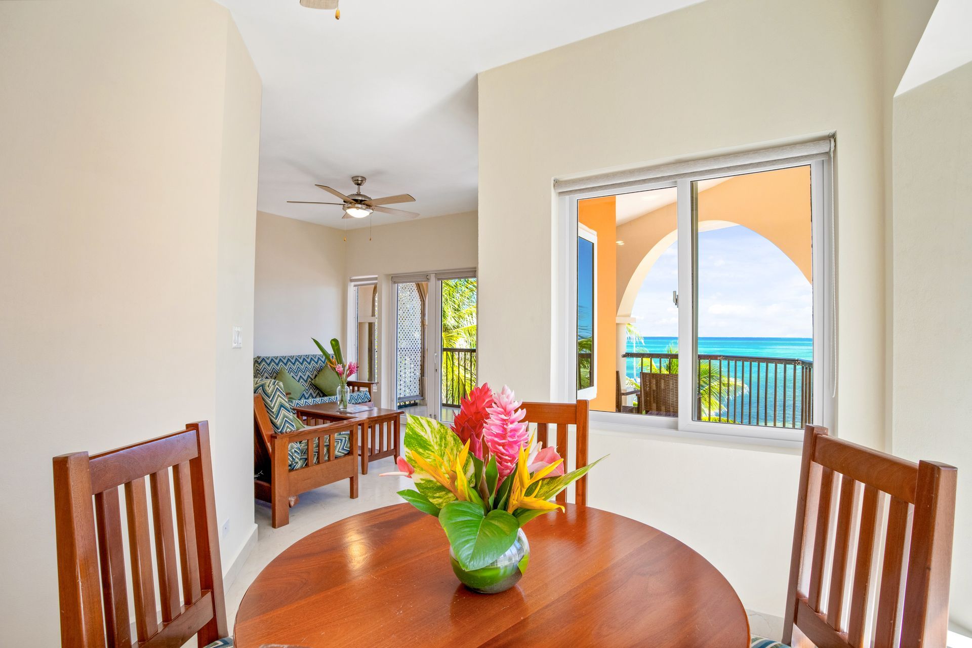 A dining room table with a vase of flowers on it