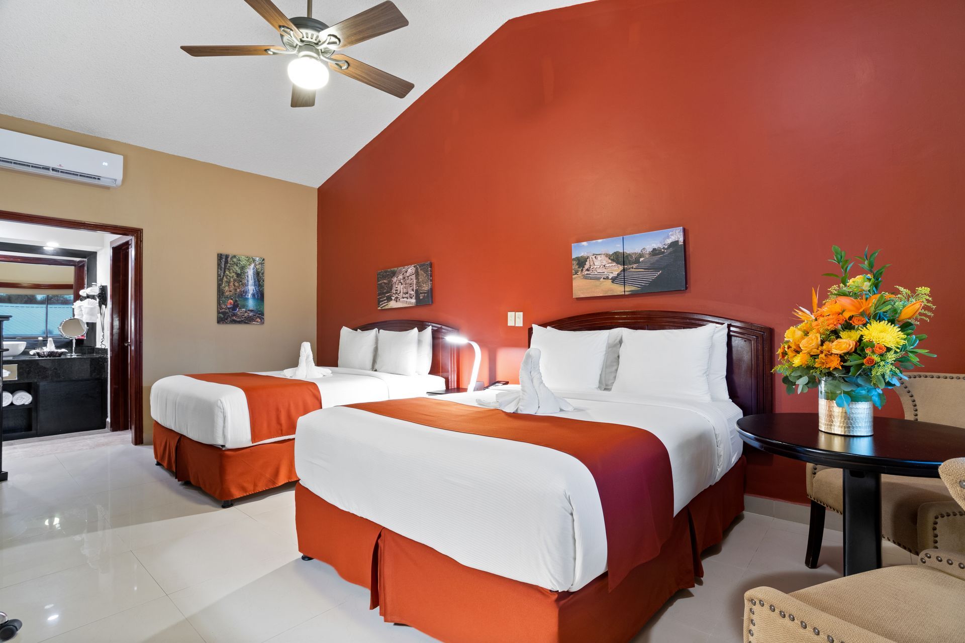 a hotel room with two beds and a ceiling fan