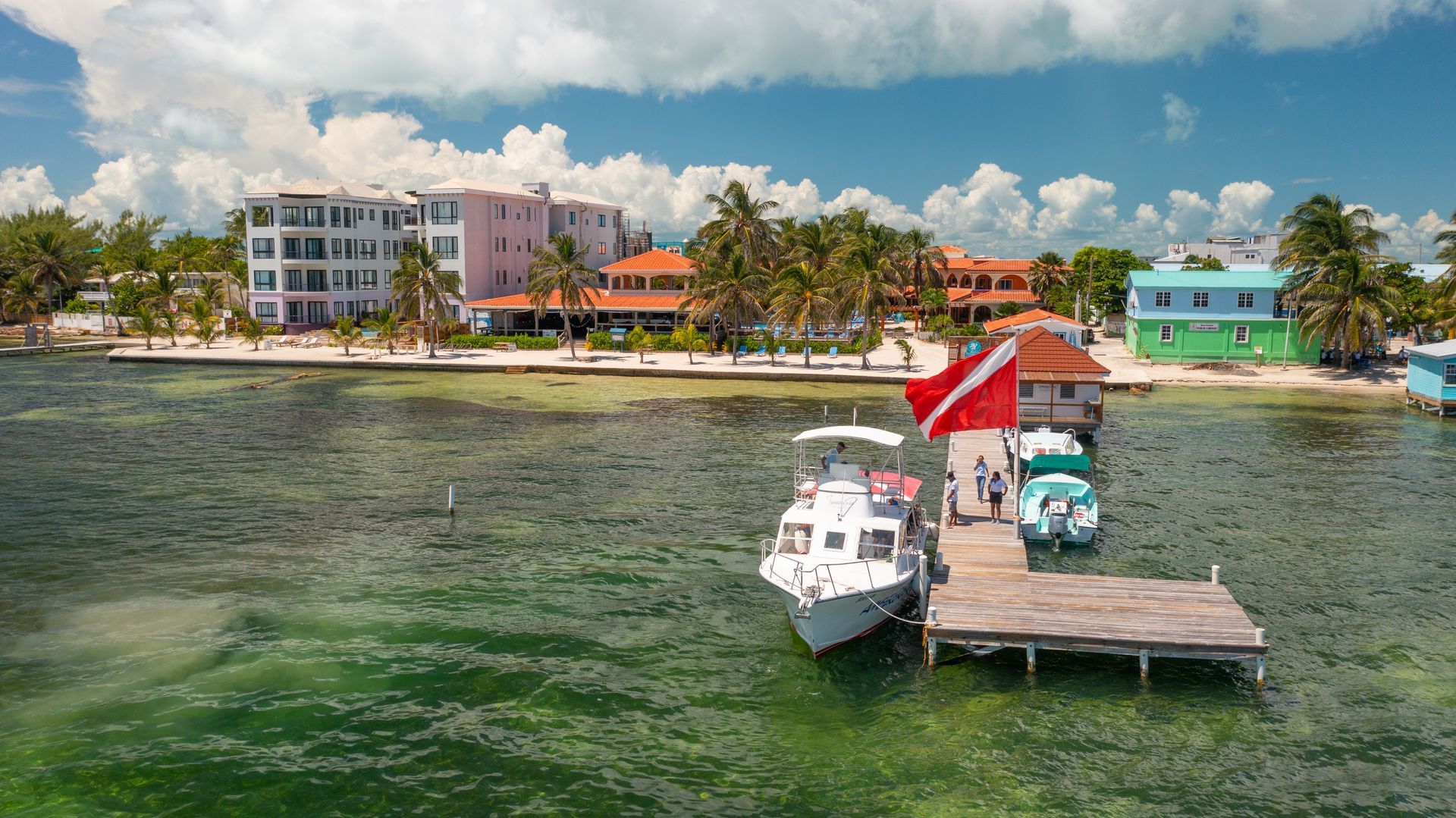 A boat is docked at a dock on a tropical island