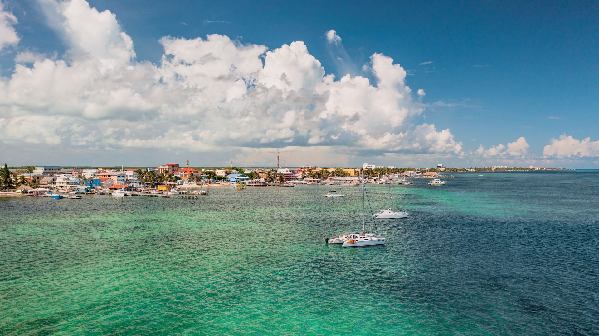 A couple of boats are floating on top of a body of water.