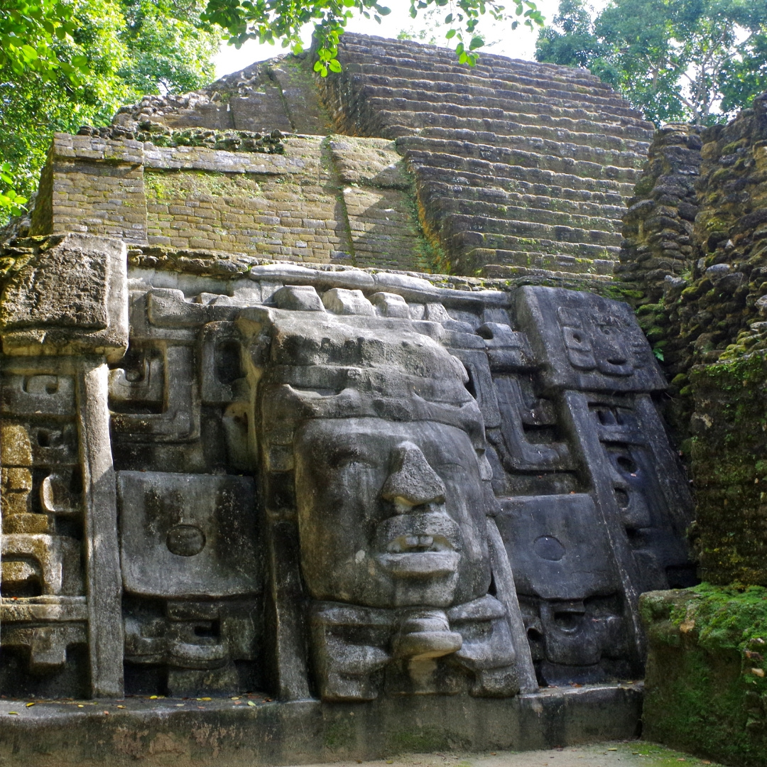 a large stone carving of a face on the side of a building .
