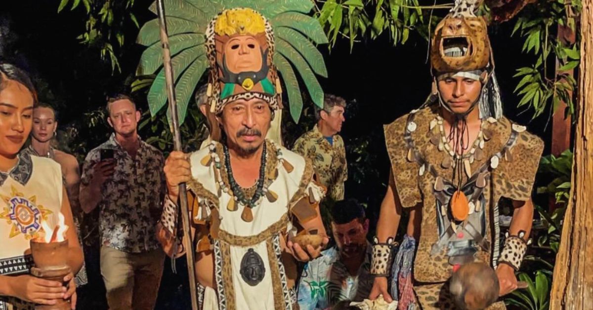 A group of people dressed in native american costumes are standing next to each other.
