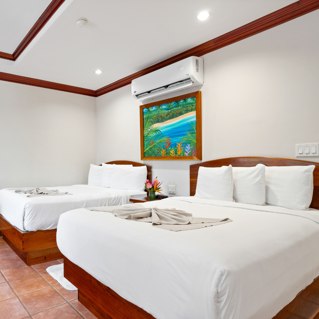 a hotel room with two beds and a picture on the wall