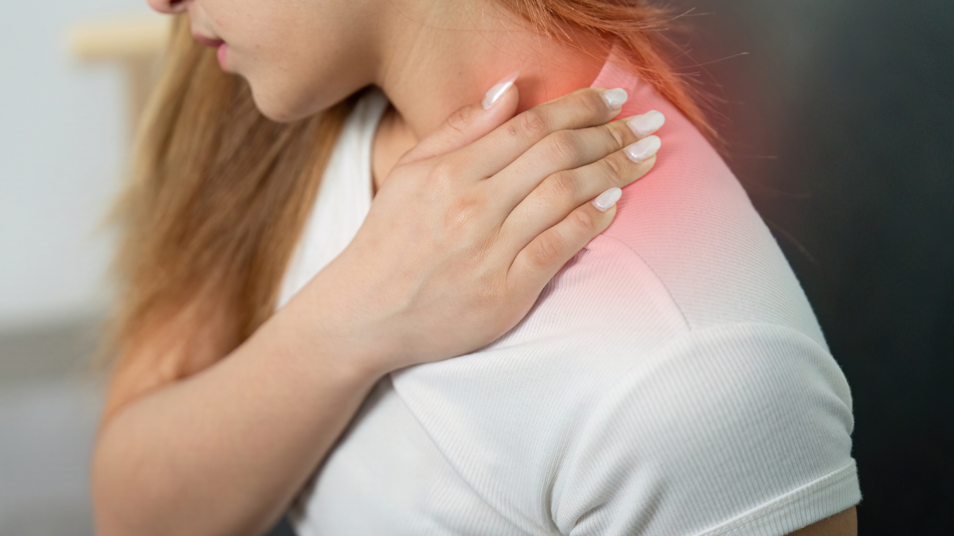A person holding their shoulder and neck, with a red glow highlighting the area of pain.