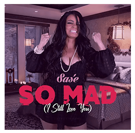 Woman in a black outfit with hands raised, red text