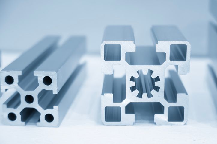 A close up of a 3d printer printing an orange object.