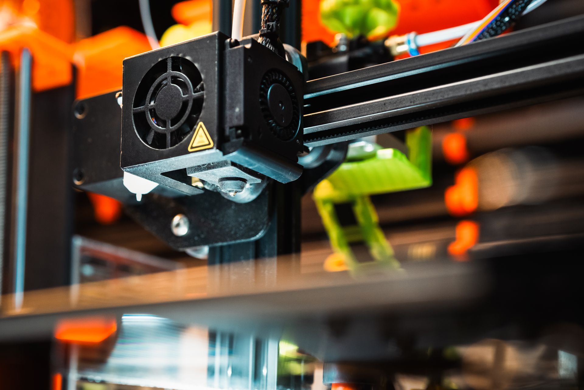 A close up of a 3d printer printing a toy.