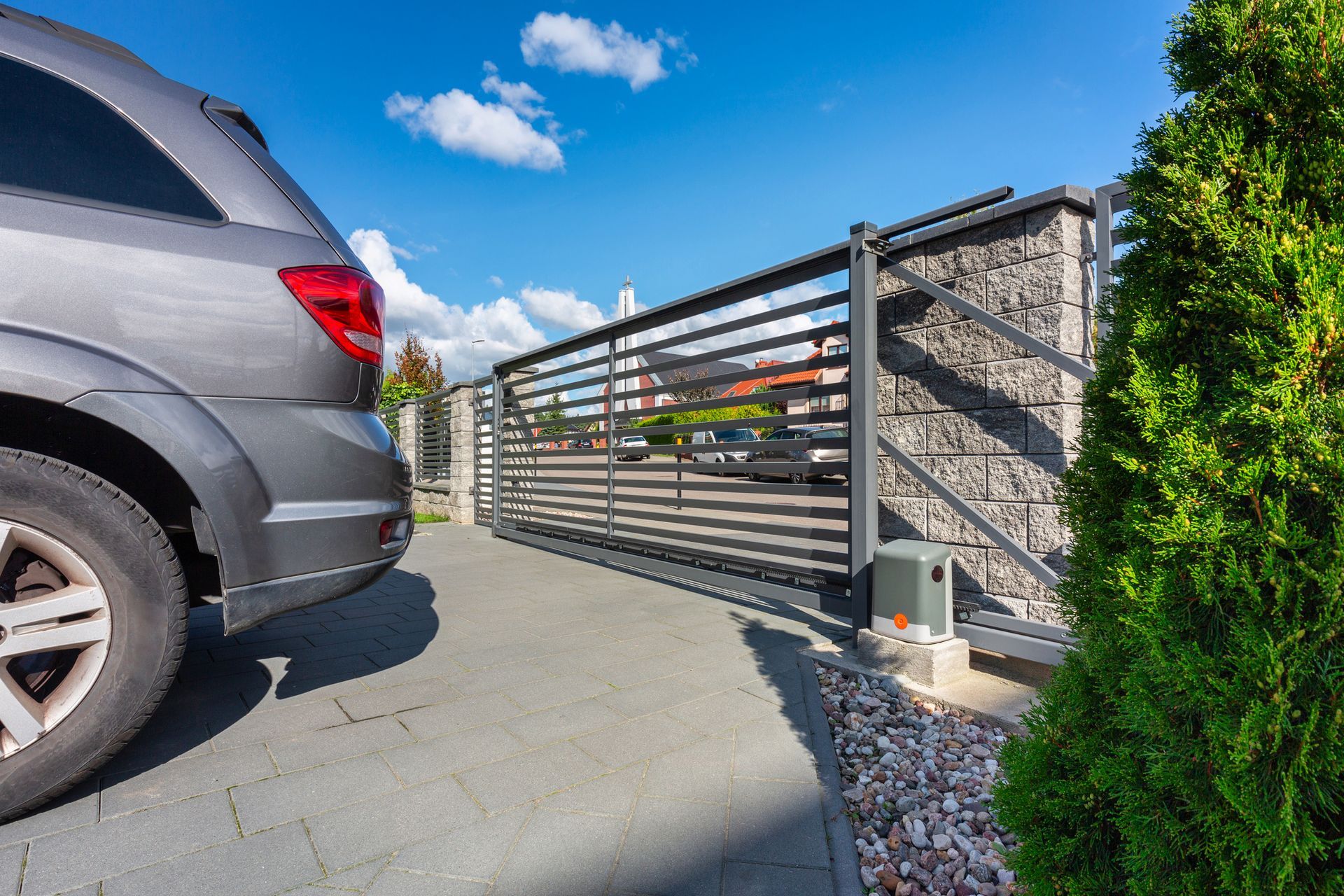 Driveway of a modern single-family house with an automatic gate.