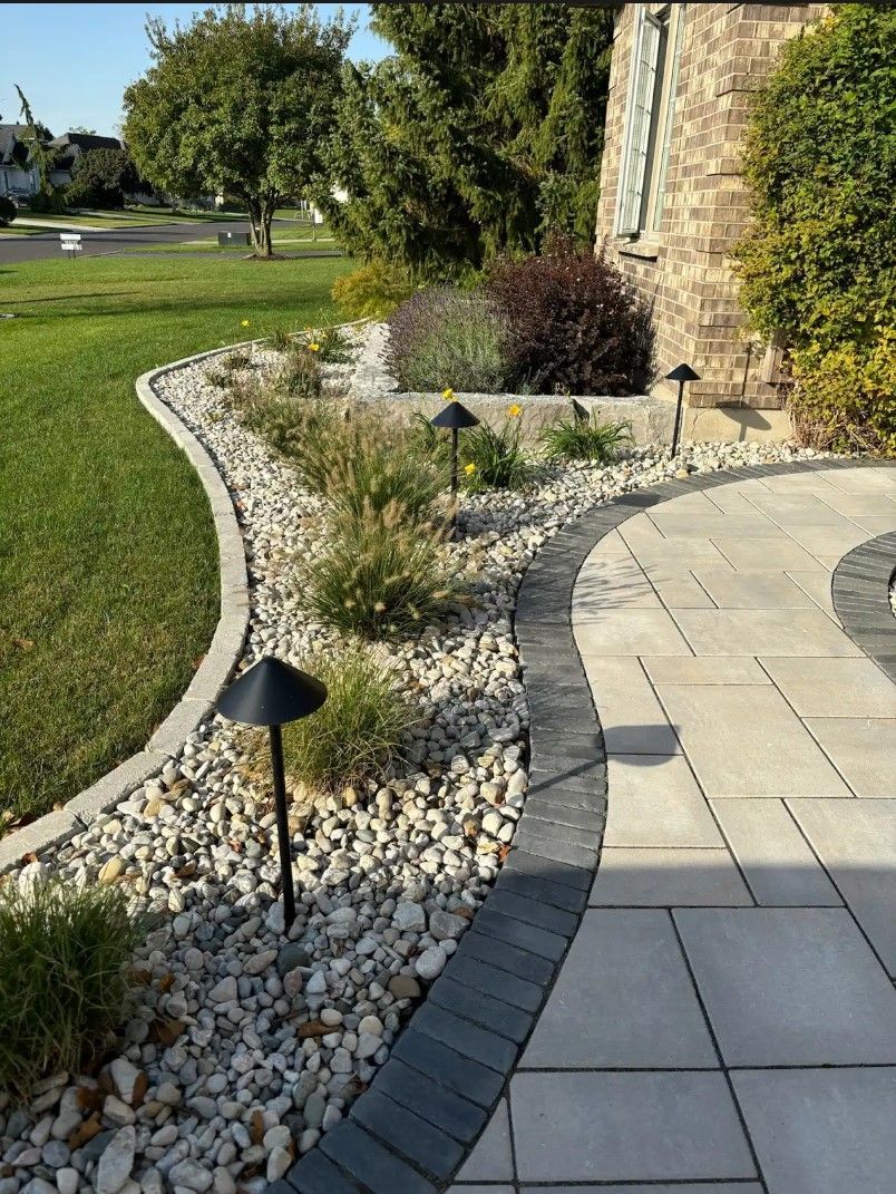 A patio with a walkway and a lawn in the background.