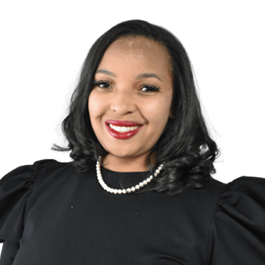 Woman with dark hair smiles, wearing a black top and pearl necklace.