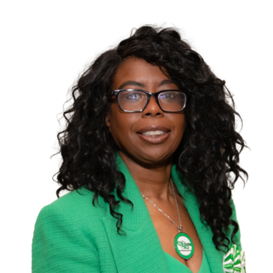 Woman wearing glasses and a green jacket, smiling.