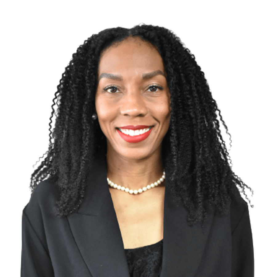 Woman smiling, wearing black blazer and pearl necklace, against a white background.