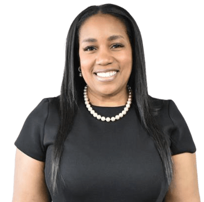 Woman smiling, wearing a black top and pearl necklace.