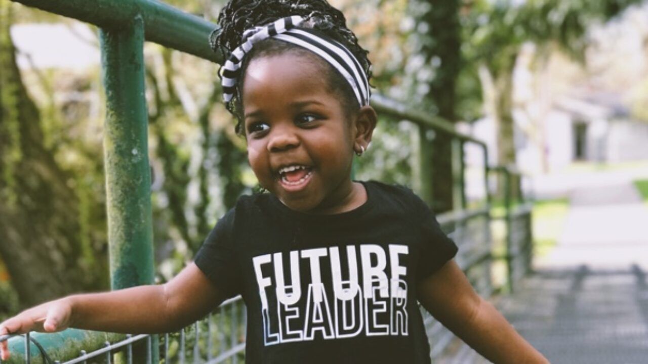 Young child with headband and black 